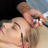 "Image of a lash and brow stain package, featuring perfectly tinted lashes and eyebrows. The treatment enhances natural features with rich, long-lasting color, providing a polished and defined look."


